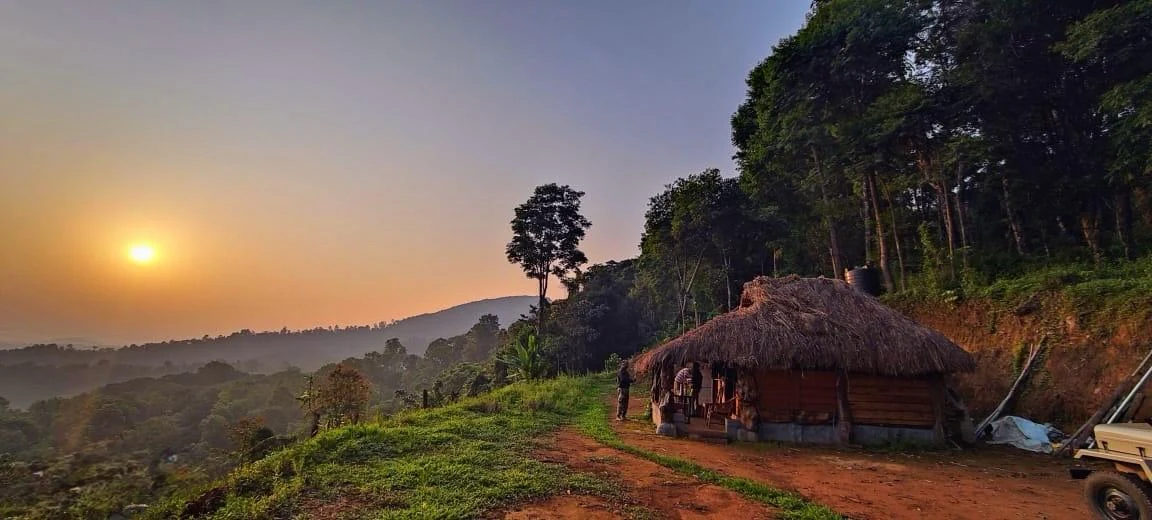 The campsite at golden hour, hut and jeep on the ridge track